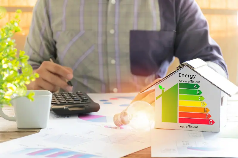 Man doing calculations to make his home more energy-efficient