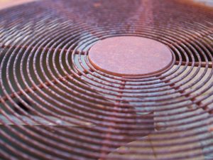 Closeup of rusted outdoor AC unit grate