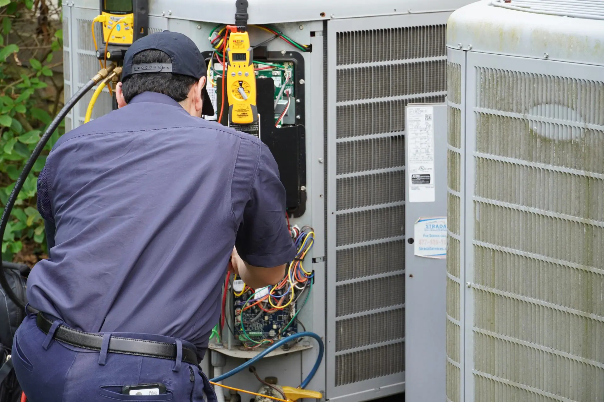Strada Service Technician working on HVAC system