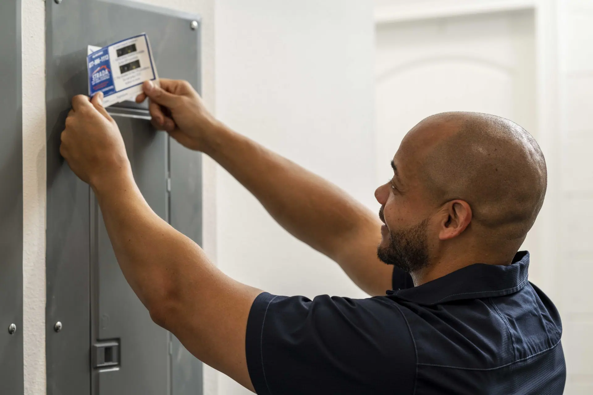 Service technician working on electrical panel