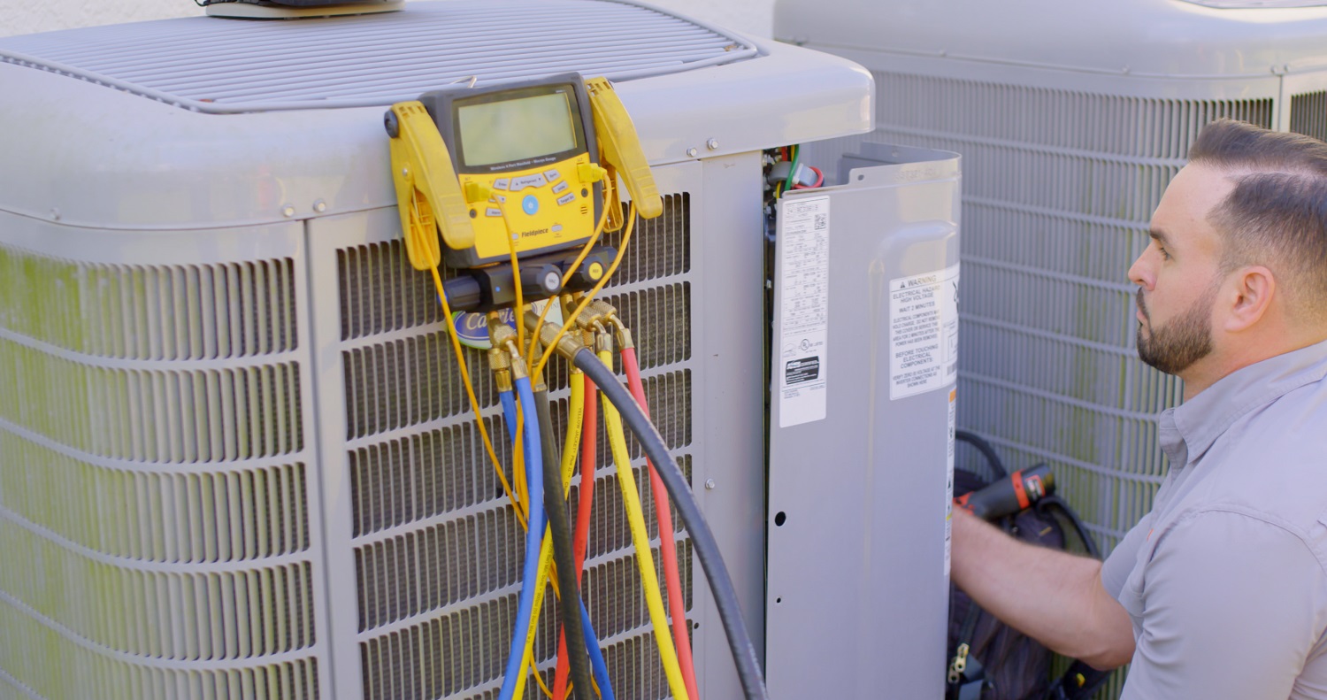 Strada Service Technician working on HVAC system