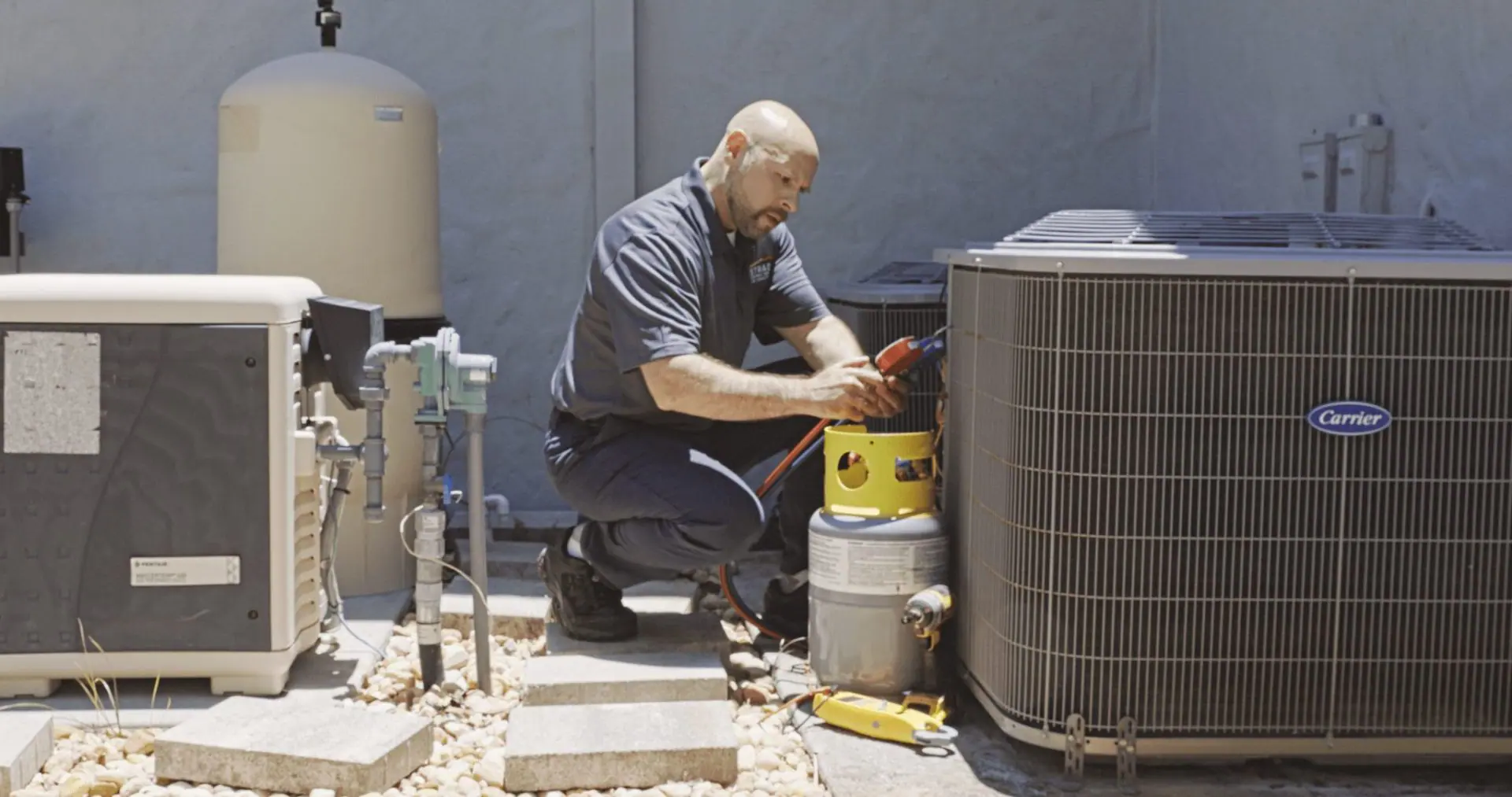 Técnico de servicio de Strada trabajando en el sistema HVAC de Carrier