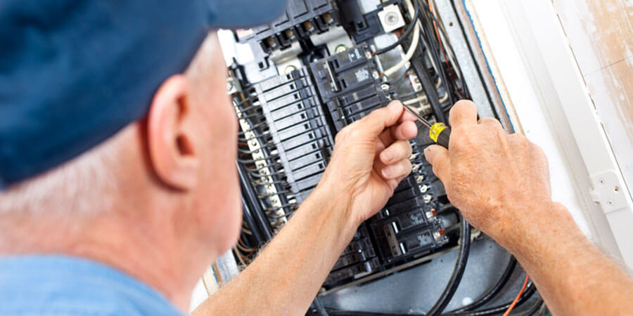 Service technician working on electrical panel