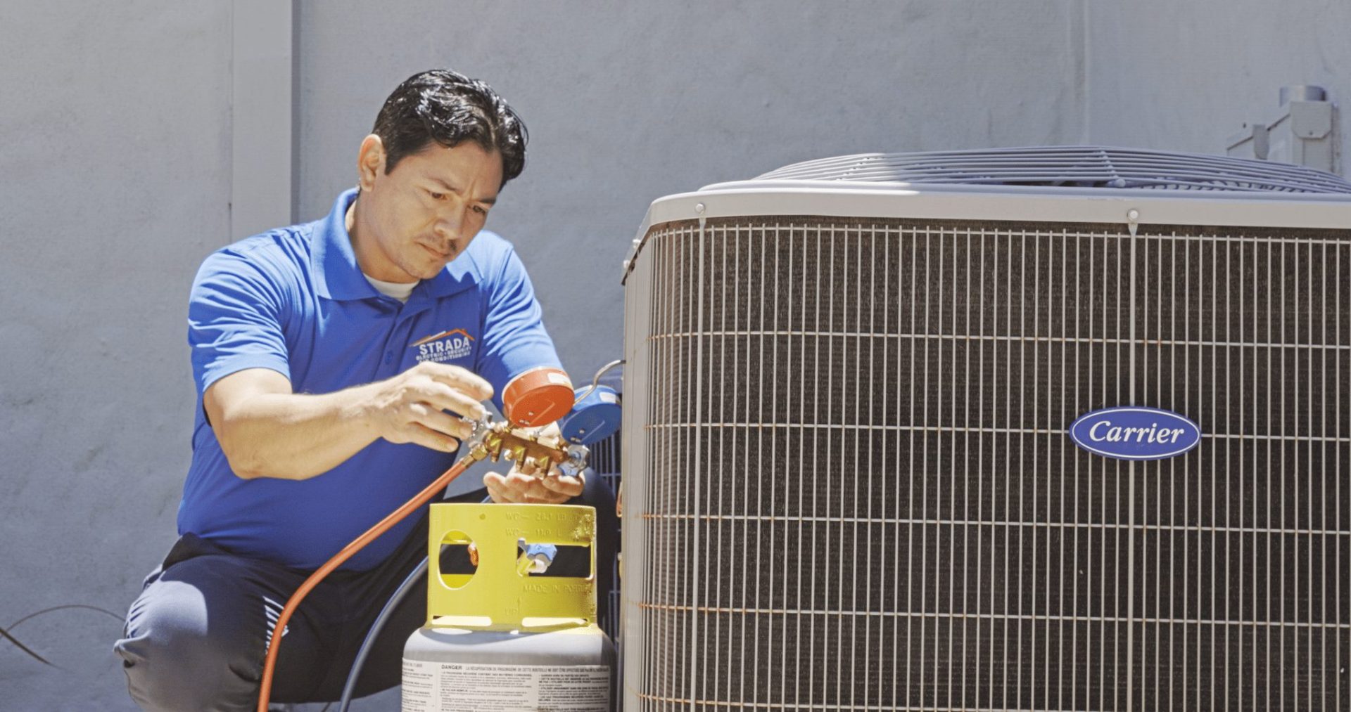 Strada Service technician working on Carrier HVAC system