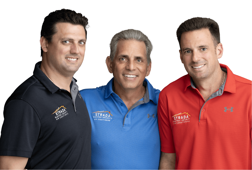 Three men are smiling. From left to right, the men are wearing a Strada Services black polo, a blue polo, and a red polo.