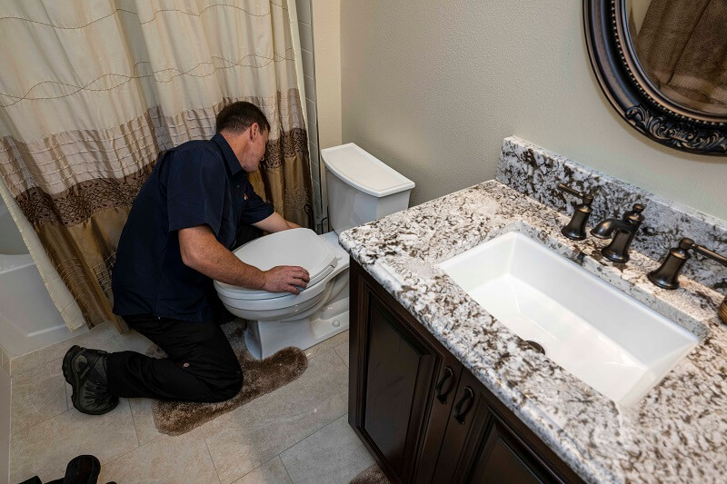 Plumber in front of toilet