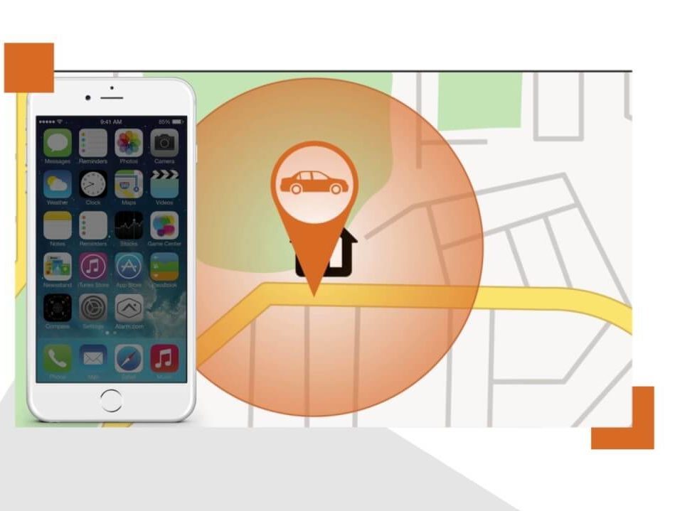 An iPhone sits in front of a digital map. There's an orange circle with a map marker symbol in front of a black house symbol.